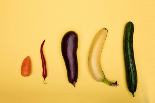 Assorted vegetables arranged in increasing size, symbolizing the range of condom sizes available to suit different anatomies, as discussed in the blog post about finding the perfect fit for safety and comfort.